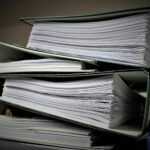 Close-up of stacked binders filled with documents for office or educational use.